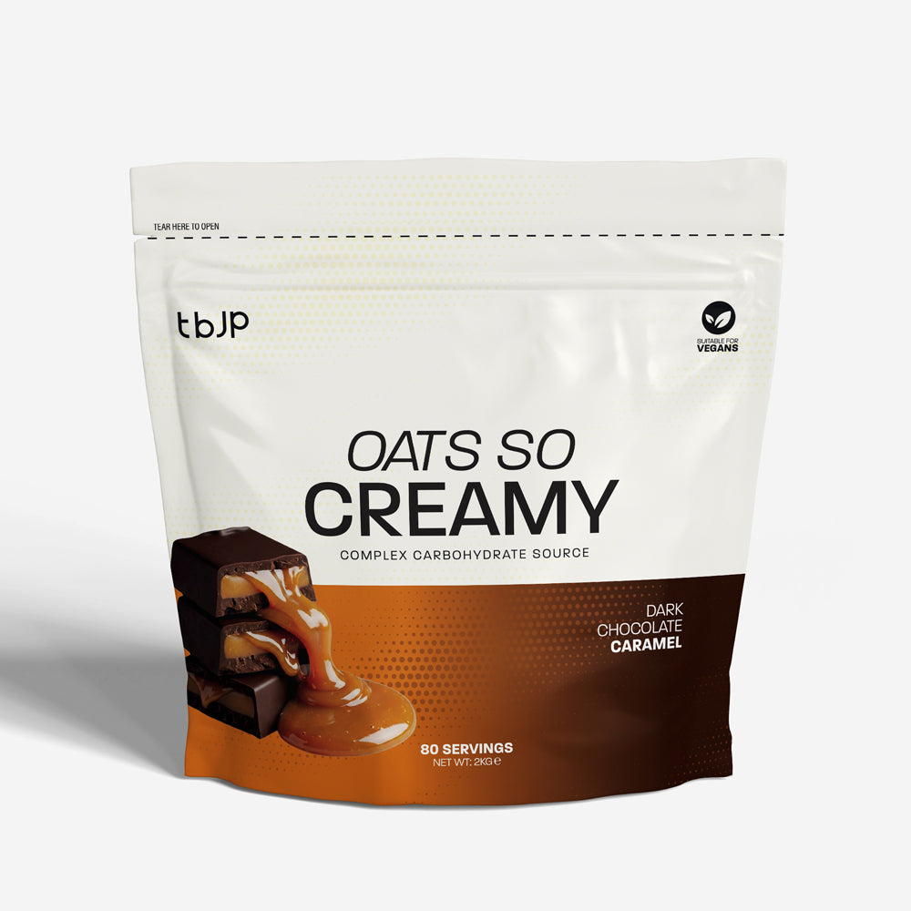 tBJP Oats So Creamy complex carbohydrate source in dark chocolate salted caramel flavor. The packaging is white on the top half and orange on the bottom half, featuring an image of chocolate slices with caramel drizzle on the lower left.