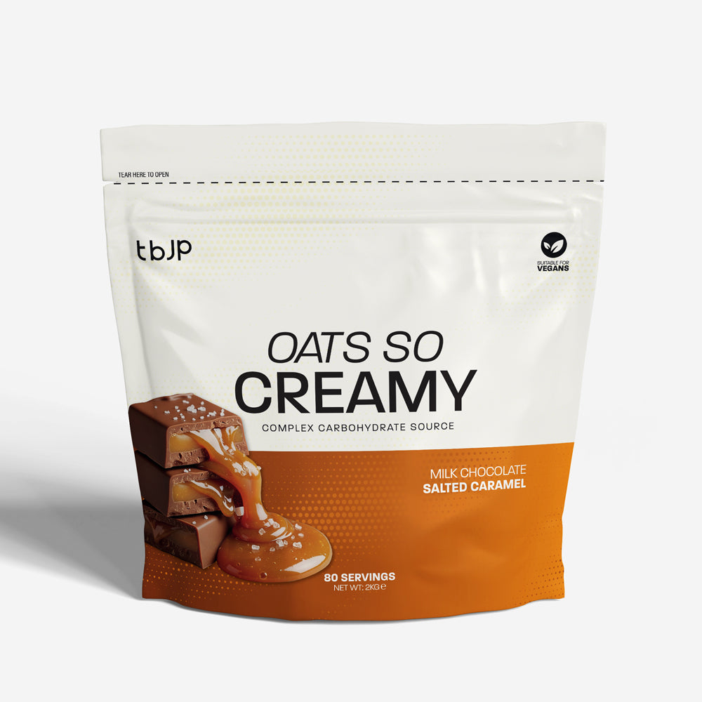 tBJP Oats So Creamy complex carbohydrate source in milk chocolate salted caramel flavor. The packaging is white on the top half and orange on the bottom half, featuring an image of chocolate slices with caramel drizzle on the lower left.