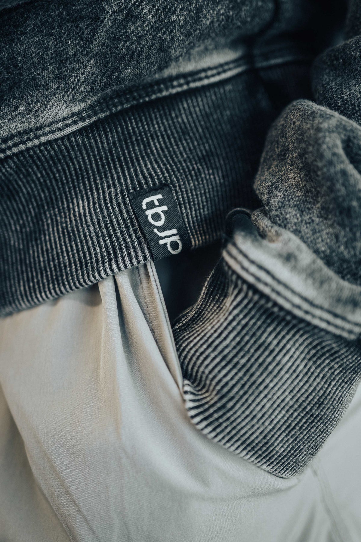 tbJP Drip Logo Sweater in Black with a Light Grey Logo
