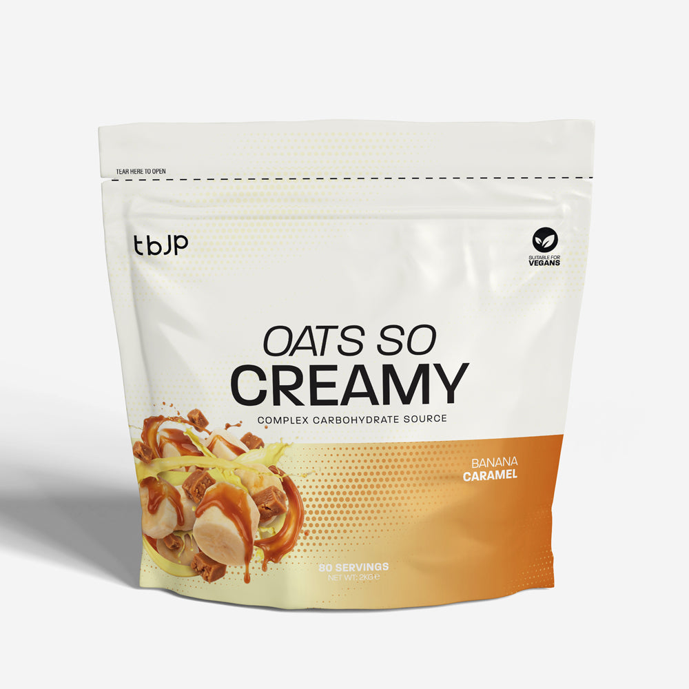 tBJP Oats So Creamy complex carbohydrate source in Banana Caramel flavor, featuring a white and orange design with a food graphic on the lower left.