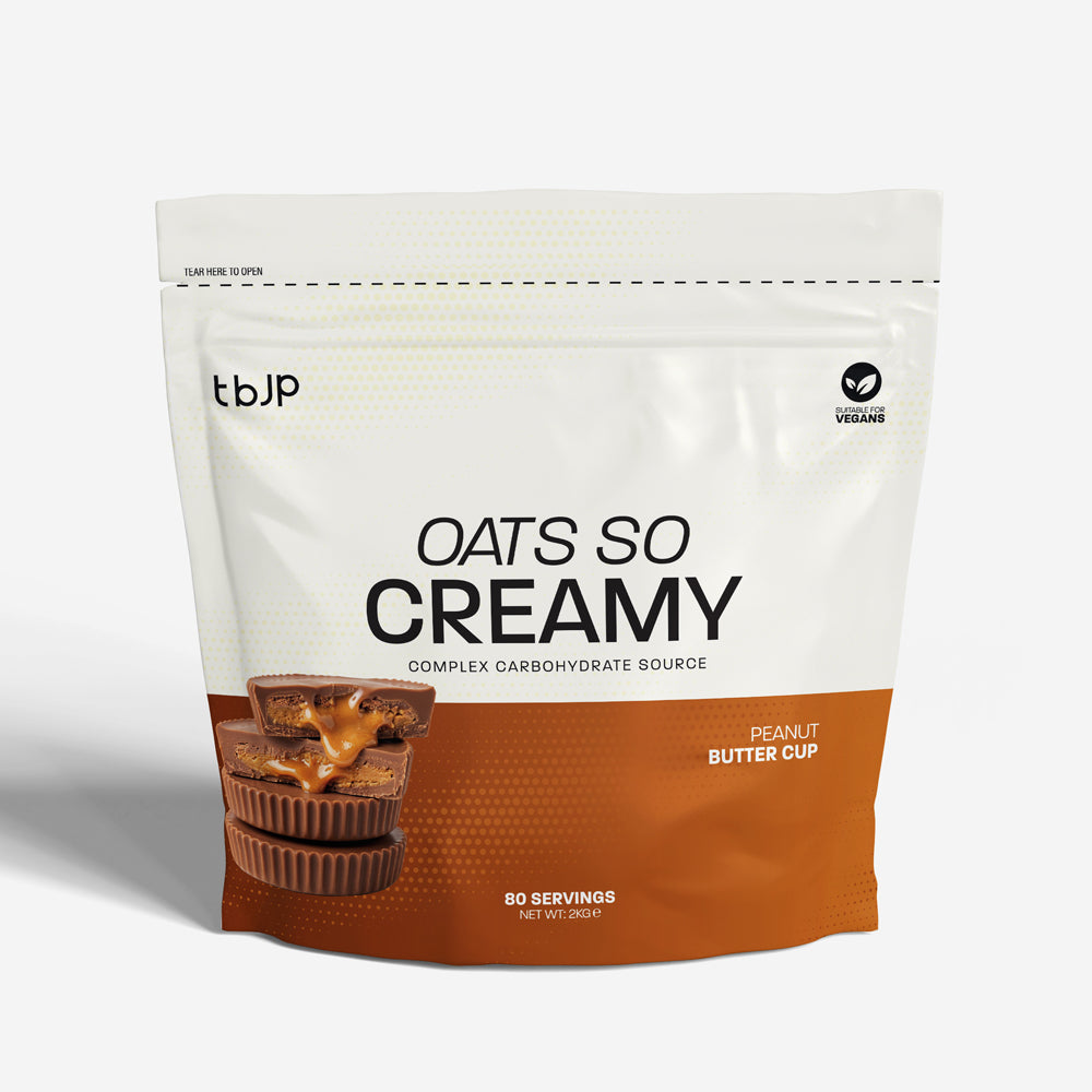 tBJP Oats So Creamy Peanut Butter Cup powder, featuring a white and orange design with a photo of peanut butter cups on the front, set against a light gray background.